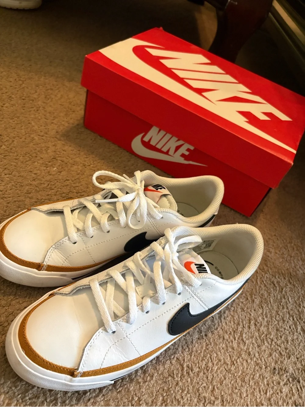 Nike White Sneakers with Black Swoosh and Gold Trim